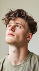 Fototapeta premium A man with a shaved head and a beard is looking up at the camera