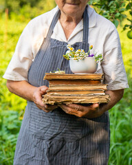 Woman with medicinal herbs in a meadow. Selective focus.