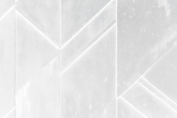 Geometric black textured wall with a repeating pattern of triangular shapes.