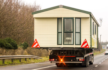 A Lorry Carrying A Static Caravan Home To It's Next Location And New Customer
