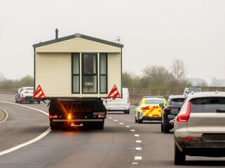A Lorry Carrying A Static Caravan Home To It's Next Location And New Customer