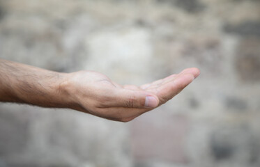 Young caucasian man showing empty hand.