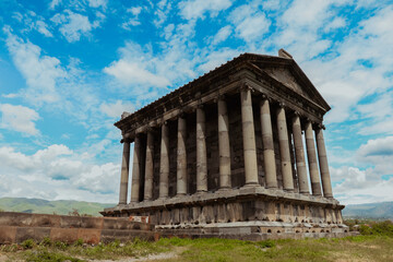 Fototapeta premium Garni Temple stands majestically against a clear sky in Armenia during daytime