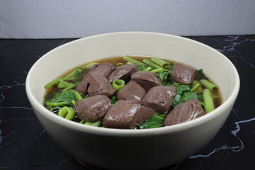 Traditional steamed pork blood soup serving in the bowl. 