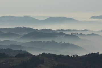 a mysterious landscape of mountains shrouded in fog and towering over the Mummelsee in Germany High quality photo