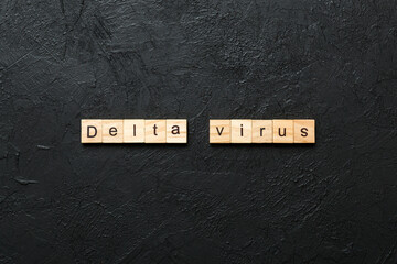 delta virus word written on wood block. delta virus text on table, concept