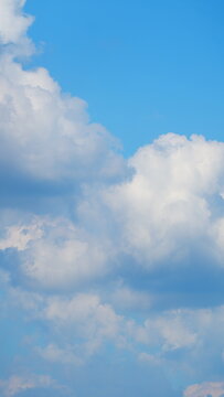 Blue Sky With White Clouds During Spring Time In A Sunny Day. Nice Blue Sky With Sun Beam With Cloudy. Vertical Time Lapse.