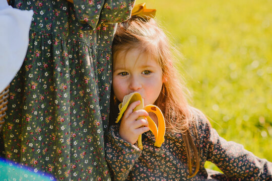 A little girl with babane and a picnic basket 