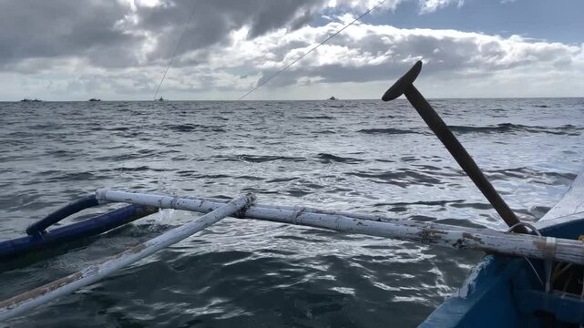 First-person view of the sea from a sailing boat whose outriggers banging against the waves