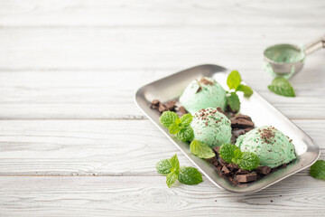 Mint chocolate ice cream balls  in iron tray on white background