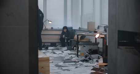 Diverse investigation team working at crime scene: Female forensic scientist takes photos of...