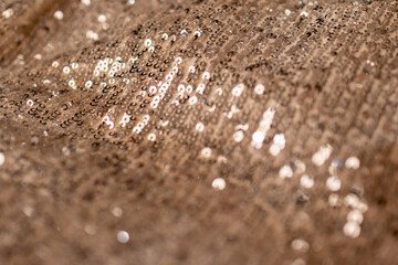 Horizontal metallic background of golden bronze sequins.