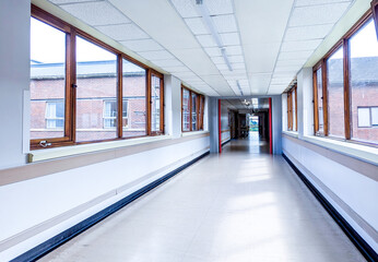 A Long Hospital Corridor Where Patients And Staff Transit From Room To Room Or Level To Level