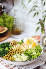 A bowl with a salad made of green vegetables