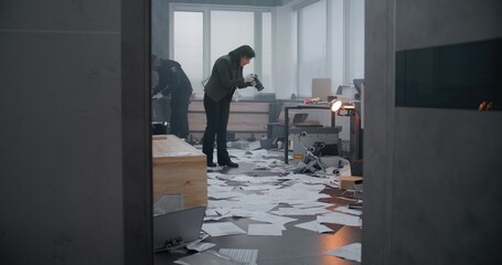 Investigation team working at crime scene: Female criminalist takes photos of evidence, African...