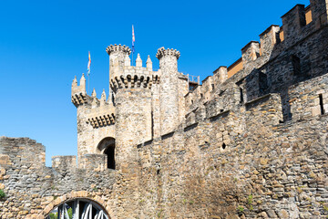 Detailed view of the facade of the Templar Castle in Ponferrada, Spain, showing its stone towers...
