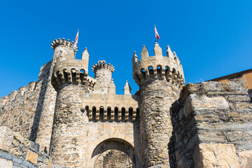 Detailed view of the facade of the Templar Castle in Ponferrada, Spain, showing its stone towers...