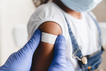 Covid 19 measles, ebola vaccinated. Doctor pediatrician injecting making vaccine to little african...