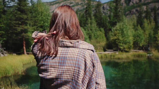 tourist on Blue geyser lake in autumn forest after snowfall. Altai, Siberia, Russia. Beautiful autumn landscape