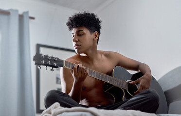 Guitar, creative and man in home playing music for learning chords, tuning or songwriting in...