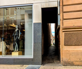 A long narrow alleyway for people to pass through usually found between buildings / property...