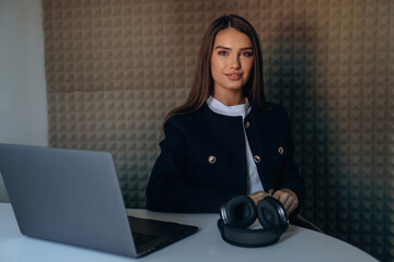 Woman is sitting and working by using laptop
