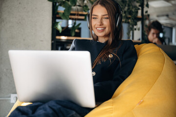 Woman is sitting and working by using laptop