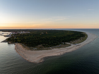 Obraz premium Hel beach in Poland. Sunset at sea and bay, Poland.Hel city. Aerial view of Hel Peninsula in Poland, Baltic Sea and Puck Bay. Aerial video made by drone from above. End of poland hel peninsula.