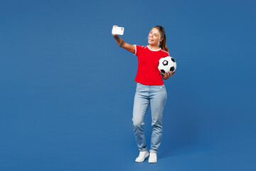 Full body young woman fan wear red t-shirt cheer up support football sport team hold in hand soccer...