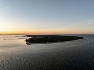 Hel beach in Poland. Sunset at sea and bay, Poland.Hel city. Aerial view of Hel Peninsula in Poland, Baltic Sea and Puck Bay. Aerial video made by drone from above. End of poland hel peninsula.