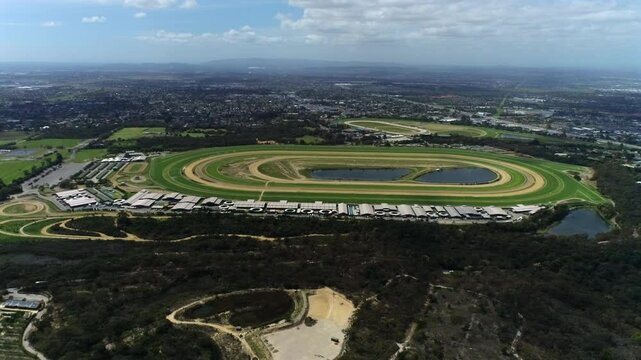 Lateral pan showcasing grass horse racing track