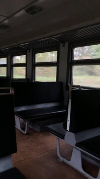 View from the window of an empty train. On a train without people, natural landscapes change outside the window.