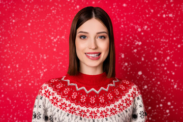 Photo of dreamy tricky young woman dressed prink pullover smiling biting lip isolated red color background