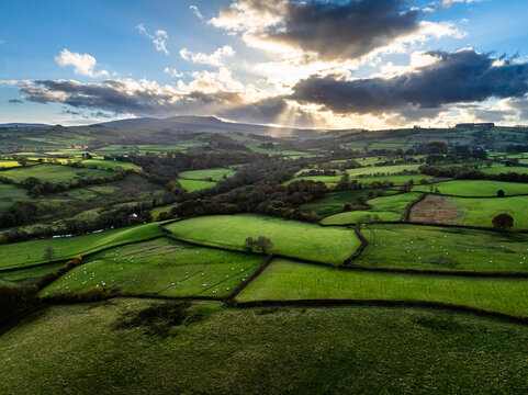 Farms over Trecastle from a drone at sunset, Brecon Beacons National Park, Powys, Wales, England