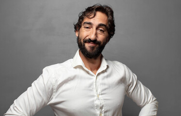 Obraz premium smiling happily with a hands on hip and confident, proud and friendly attitude