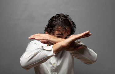 covering face with hand and putting other hand up front to stop camera, refusing photos or pictures