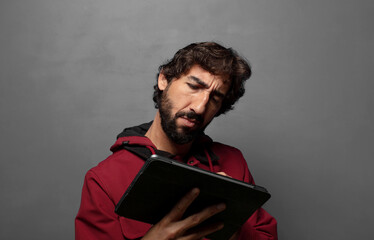 young adult man using a touch screen tablet