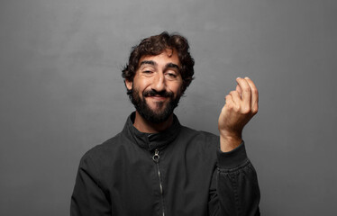 Fototapeta premium making capice or money gesture, telling you to pay your debts!
