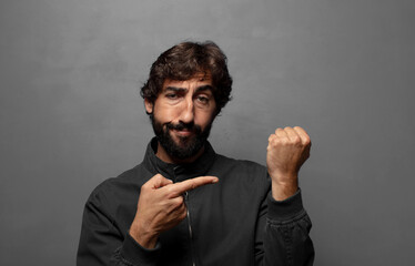 looking impatient and angry, pointing at watch, asking for punctuality, wants to be on time