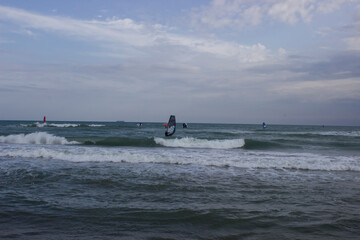 Fototapeta premium Surfers ride the waves in the sea.