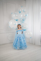 Fototapeta premium little girl in blue dress with giant helium balloons 