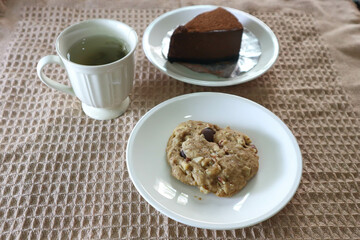 almond cookie , hot tea and chocolate cake