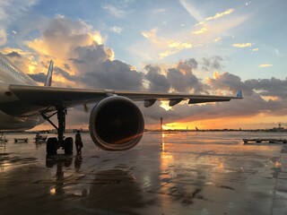 Airplane at Sunset on Wet Tarmac