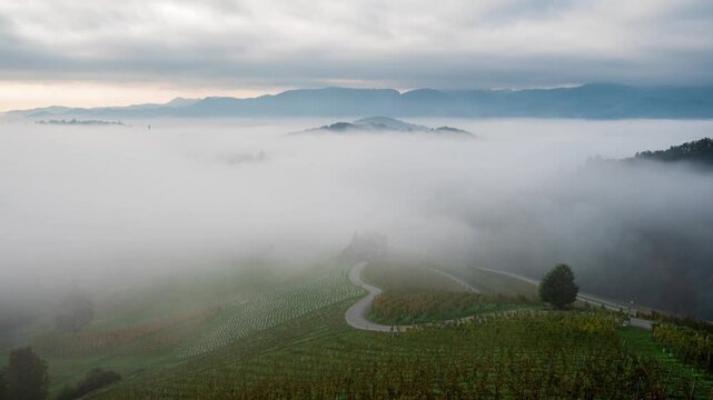 Time-lapse video of morning mists creeping over the picturesque, autumn-covered hills and the famous heart-shaped wine route near Maribor, close to the Austrian border in Slovenia