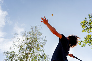 low shot professional tennis court young curly guy technically performs the first serve in the game examines it clay court markings