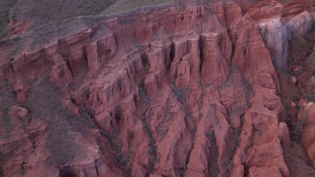 Aerial view of Kok-Moinok Canyon, a clay-sand structure formed on the slopes of arid mountains cut by water streams, Kyrgyzstan