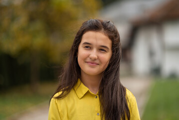 Fototapeta premium Portrait of a happy teenage girl outside.
