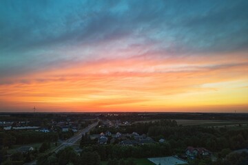 Majestic sunset with rain and colorful clouds over fields