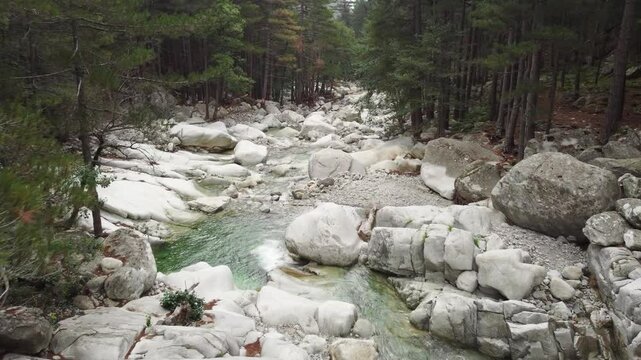 Wonderful river stream in Restonica valley, Corsica, aerial flying above waterfalls