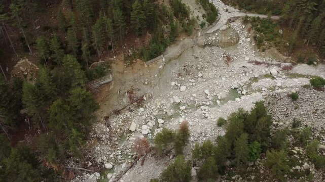 Destroyed road by river in mountain landscape, Restonica Valley, aerial shot